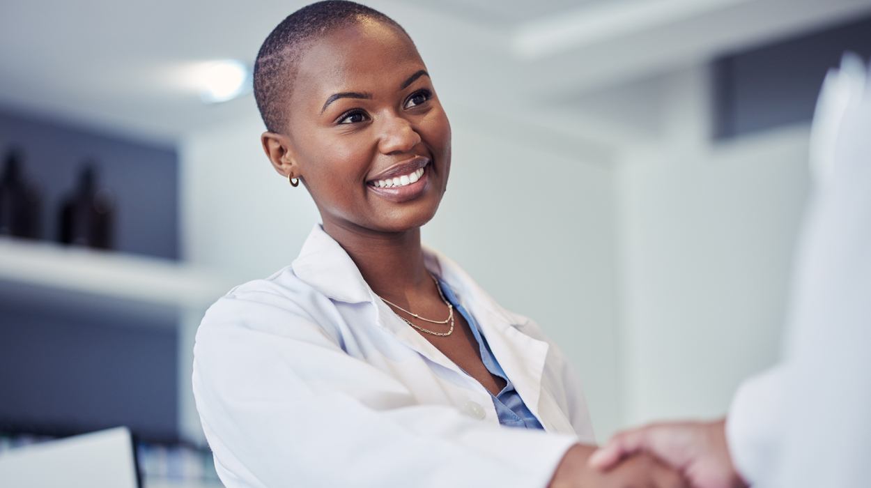 Medical Spa Physican smiling and shaking hands with an employee.