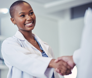 Medical Spa Physican smiling and shaking hands with an employee.