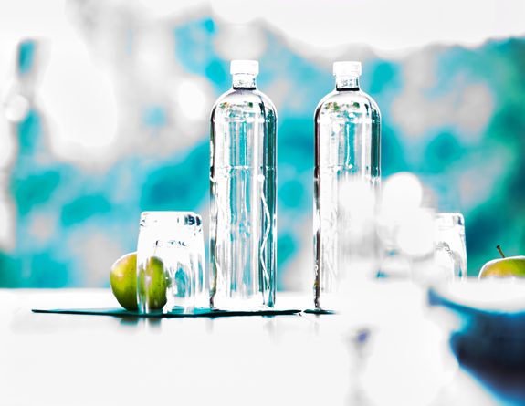 Glass water bottles and drinking glasses with fruit