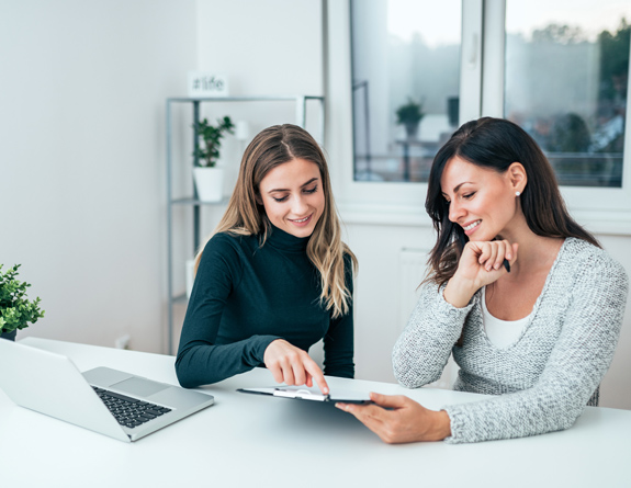 Women using the best medical spa software to plan opening event