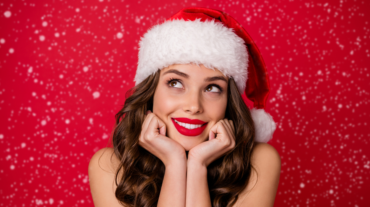 Smiling woman in Santa hat representing holiday marketing campaign for medical spa promotions