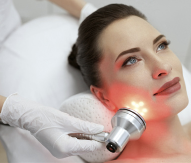 Using the best medical spa software, the client is receiving red-light therapy.