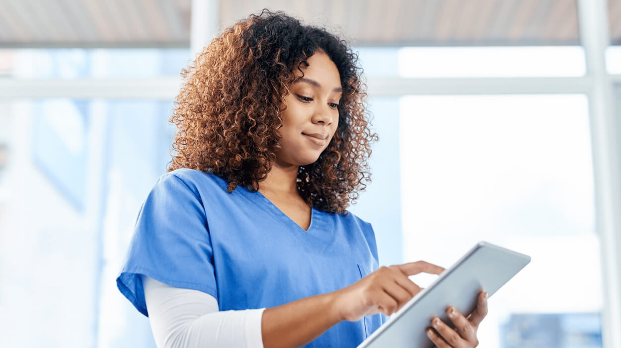 Medspa employee uses medical spa software on her tablet